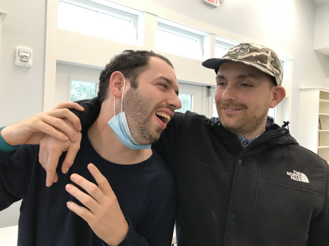 Two men laughing with each other