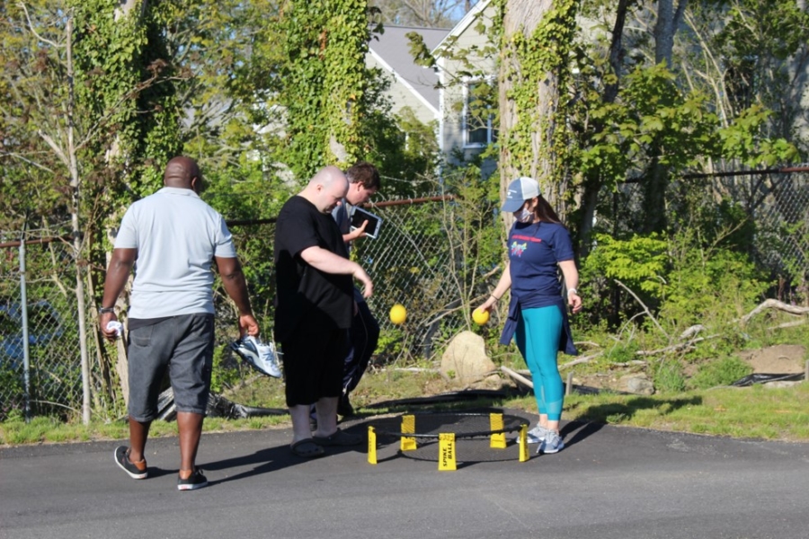 Caregiver and Cape Cod Village residents playing spike ball